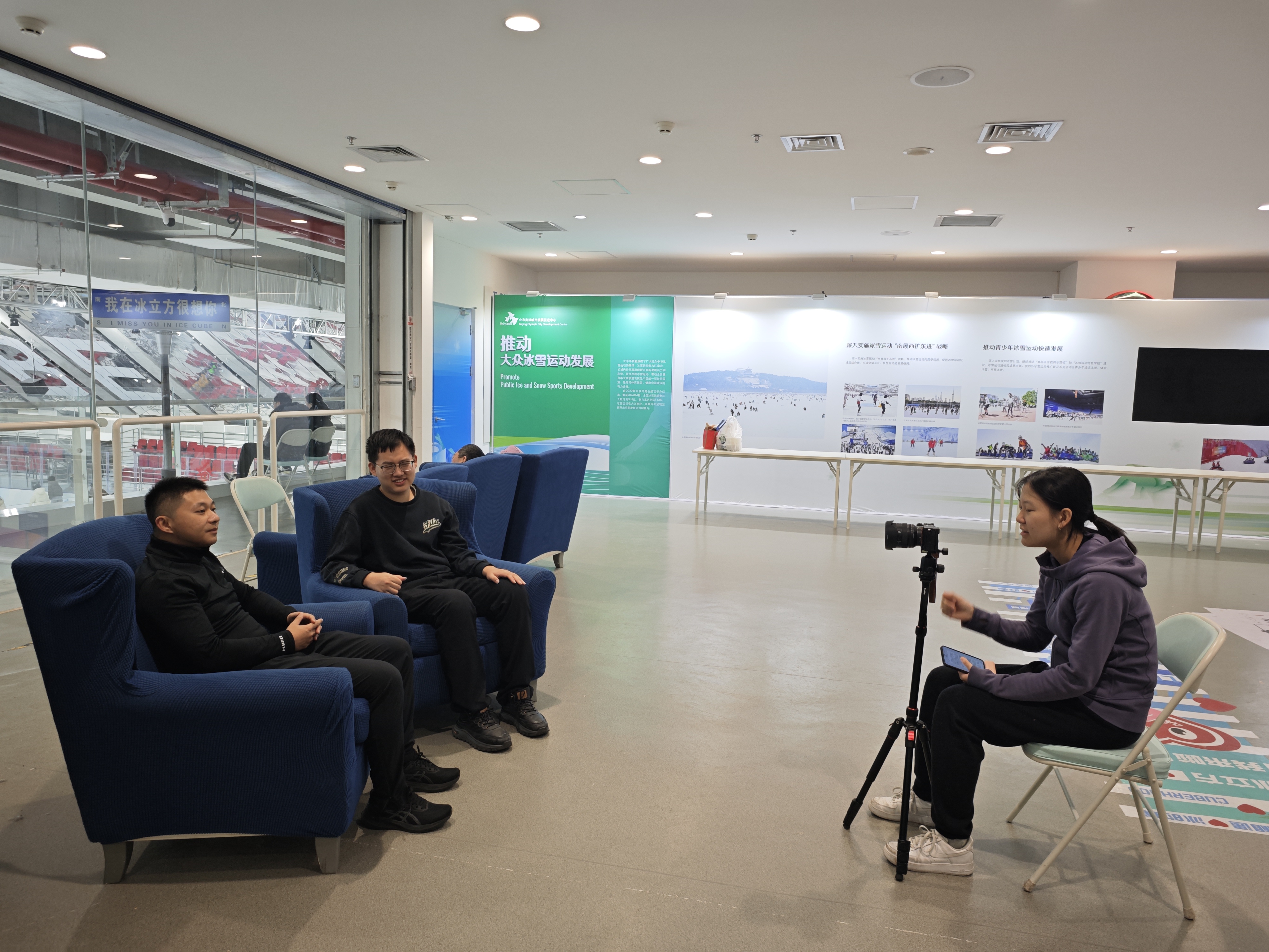 An interview being filmed beside an ice rink