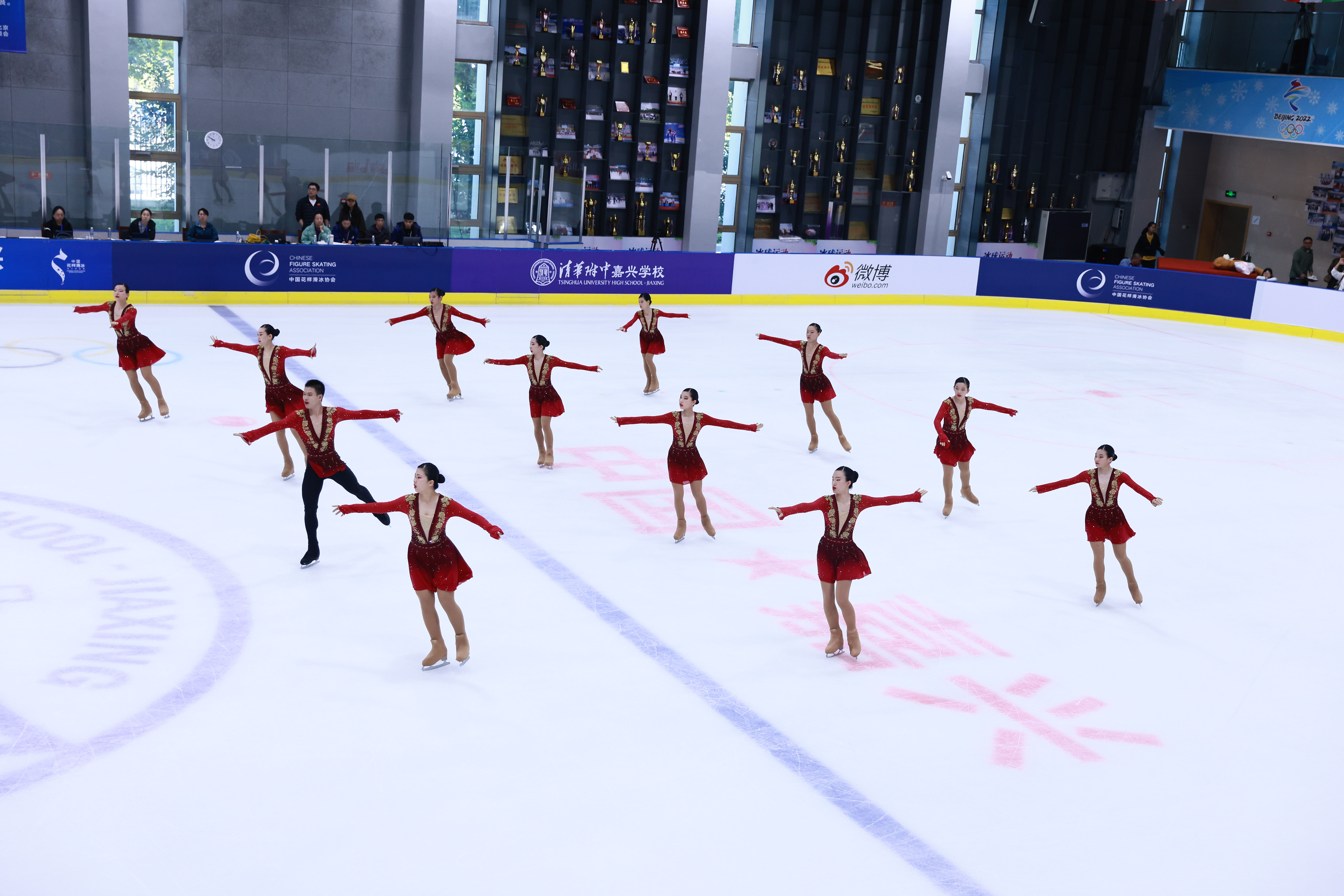 Skating team performing in red costumes